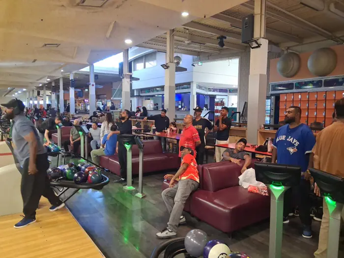 Club members and other bowlers watching a shot at the lanes