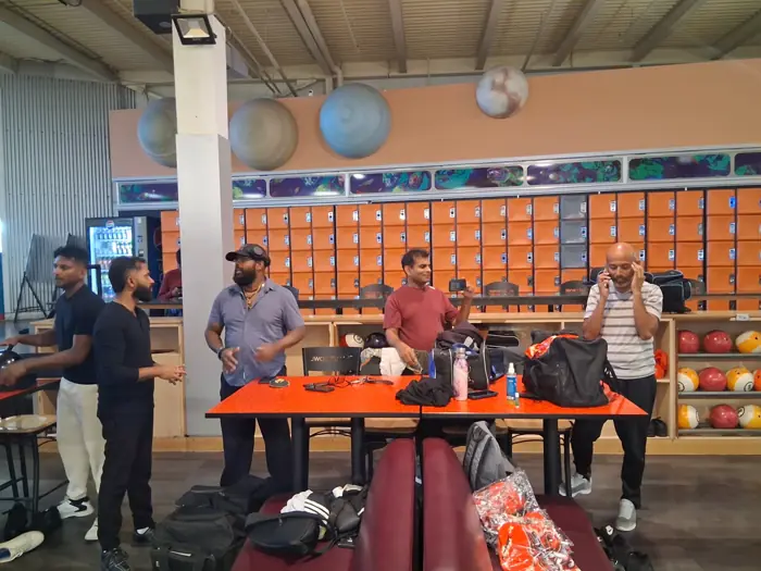Members getting ready around a table before league night